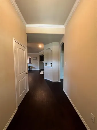 a view of hallway with wooden floor