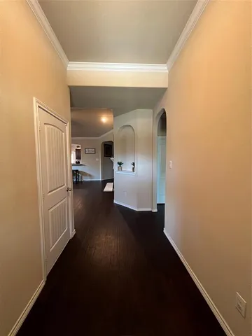 a view of hallway with wooden floor