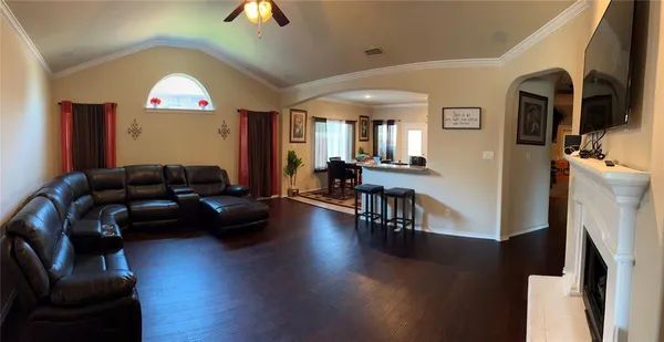 a living room with furniture and a chandelier