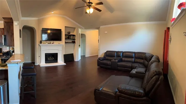 a living room with furniture fireplace and flat screen tv