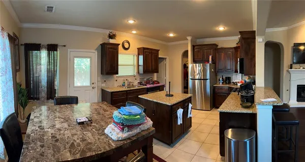 a kitchen with sink refrigerator and stove