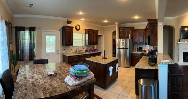 a kitchen with sink refrigerator and stove