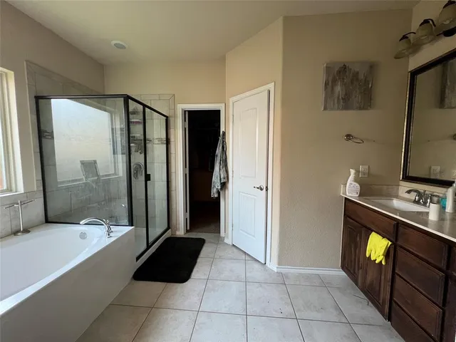a bathroom with a bathtub and a shower
