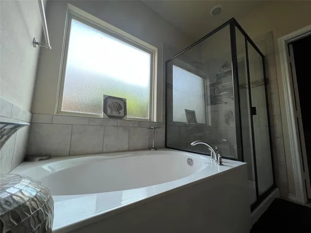 a bathroom with a bathtub and a shower