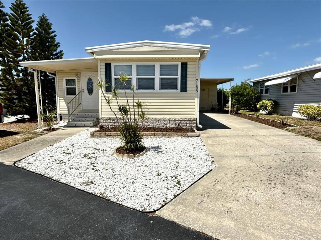 7158 Mt Bristol Road Northeast, Unit 456 St. Petersburg, FL 33702 - Photo 1 of 1 a front view of a house with garden