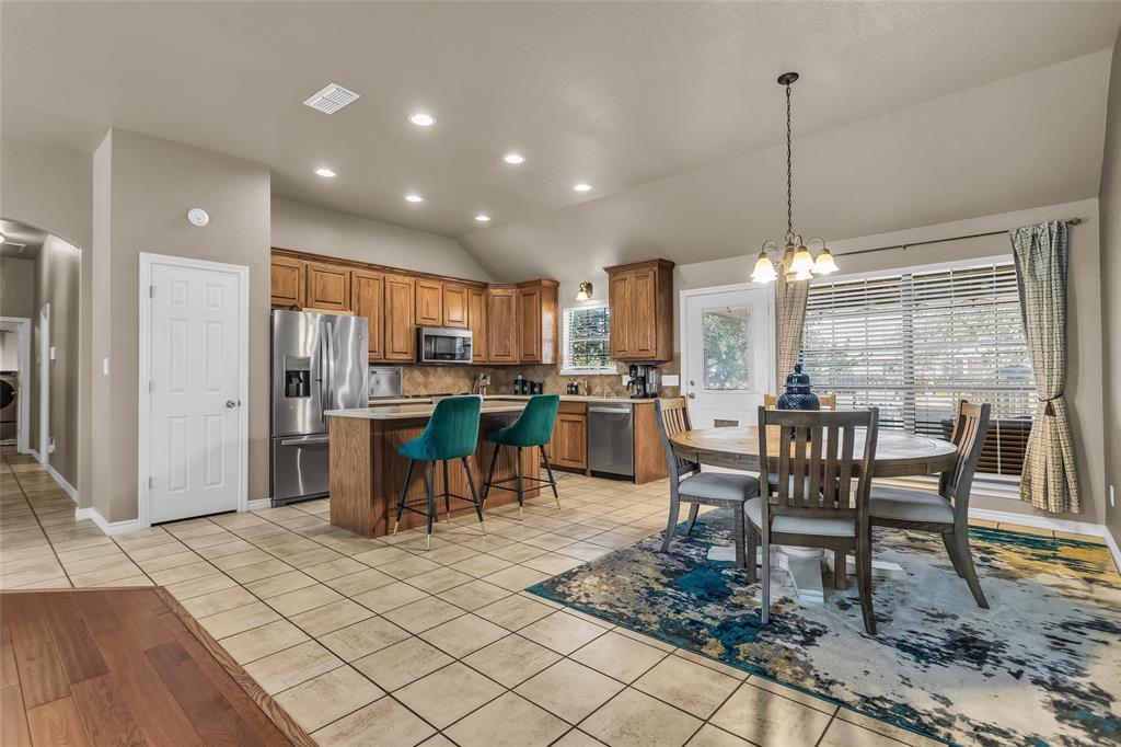 226 King George Road Ponder, TX 76259 - Photo 19 of 39 Dining space featuring a chandelier, light tile patterned floors, vaulted ceiling, recessed lighting, and arched walkways