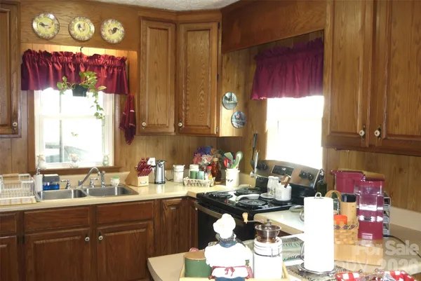 a kitchen with a sink cabinets and window