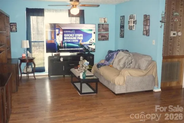 a living room with furniture and a wooden floor