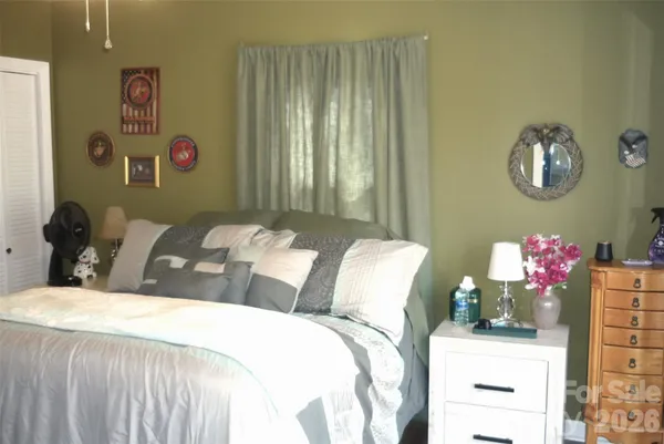 a bedroom with a bed and a dresser