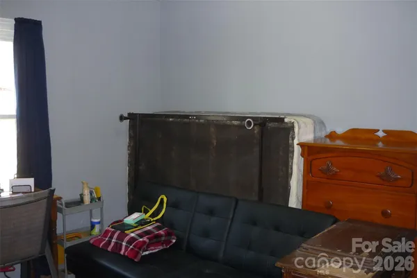 a living room with furniture and a closet