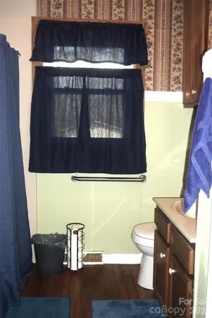 a bathroom with a sink a toilet and mirror