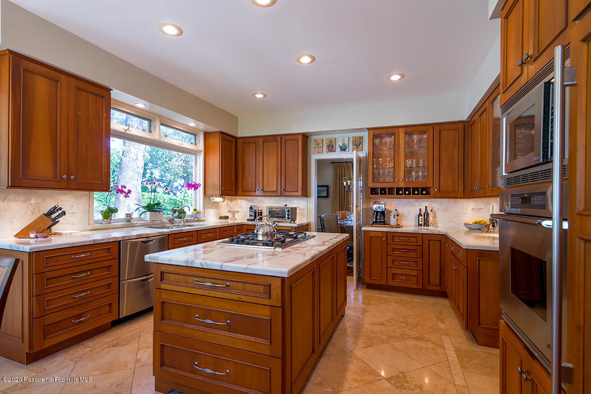 1987 Braeburn Road Altadena, CA 91001 - Photo 15 of 48 a kitchen with stainless steel appliances granite countertop wooden cabinets sink and stove top oven