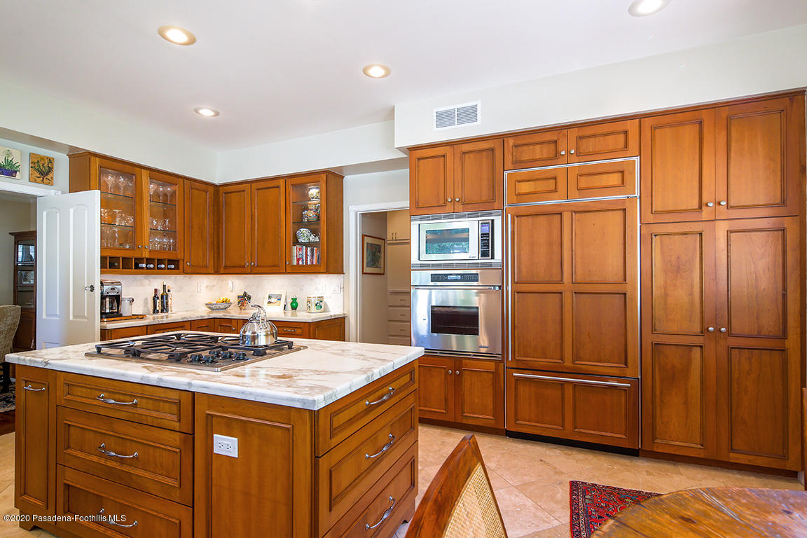 1987 Braeburn Road Altadena, CA 91001 - Photo 16 of 48 a kitchen with granite countertop stainless steel appliances a refrigerator cabinets and wooden floor