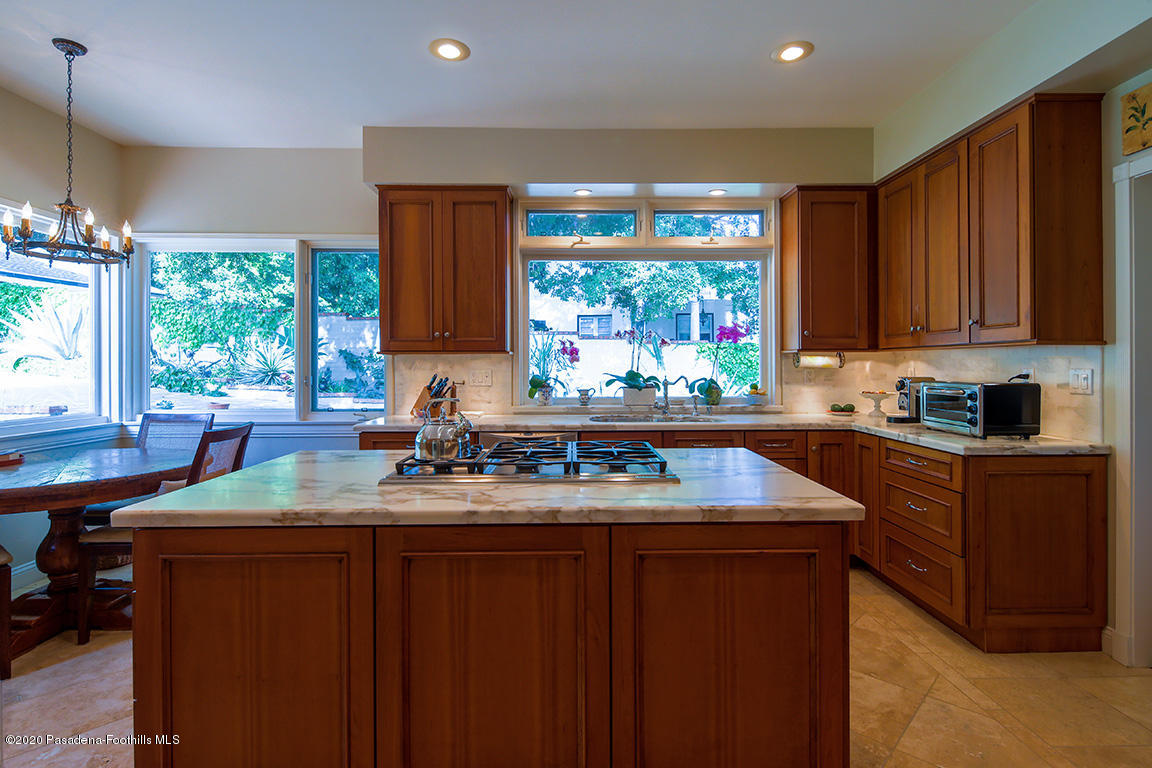 1987 Braeburn Road Altadena, CA 91001 - Photo 17 of 48 a kitchen with kitchen island granite countertop a sink window and cabinets