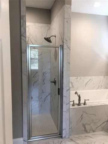 a bathroom with a glass shower door