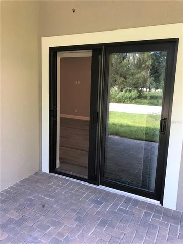 a view of a green field with sunset in the background