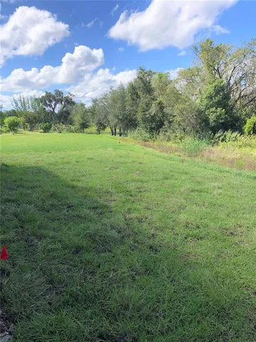 a backyard of a house with a yard and outdoor seating