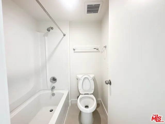 a bathroom with a toilet and a bathtub