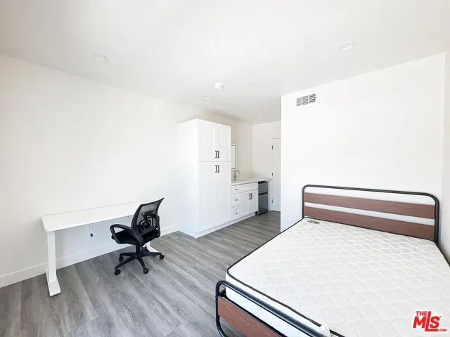 a bedroom with a bed and a desk