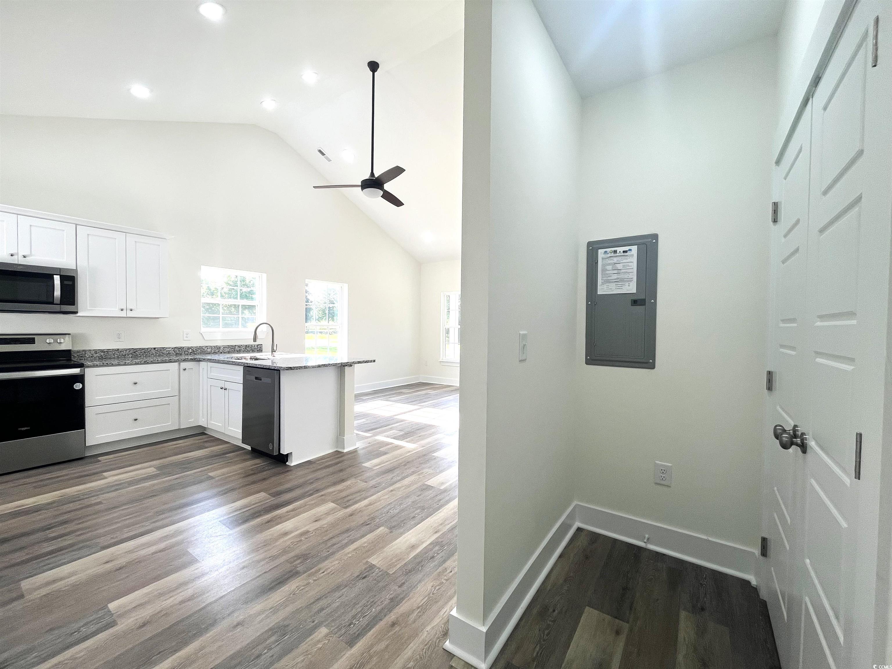 1174 St John Road Galivants Ferry, SC 29544 - Photo 11 of 22 Kitchen with appliances with stainless steel finishes, electric panel, a peninsula, a ceiling fan, and white cabinetry
