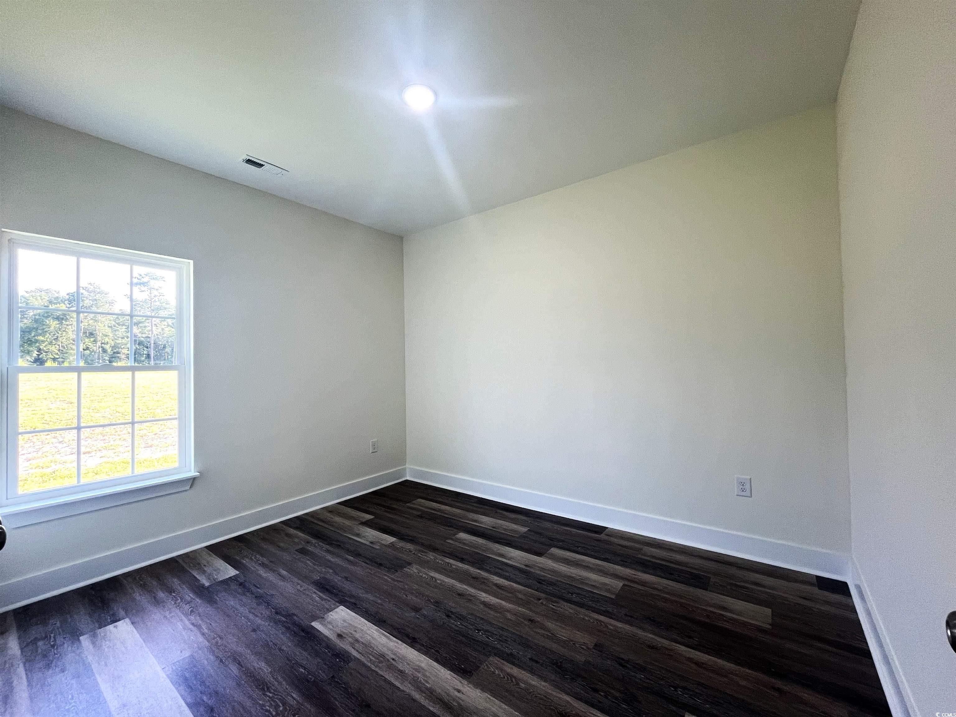1174 St John Road Galivants Ferry, SC 29544 - Photo 17 of 22 Spare room featuring dark wood-style floors and baseboards