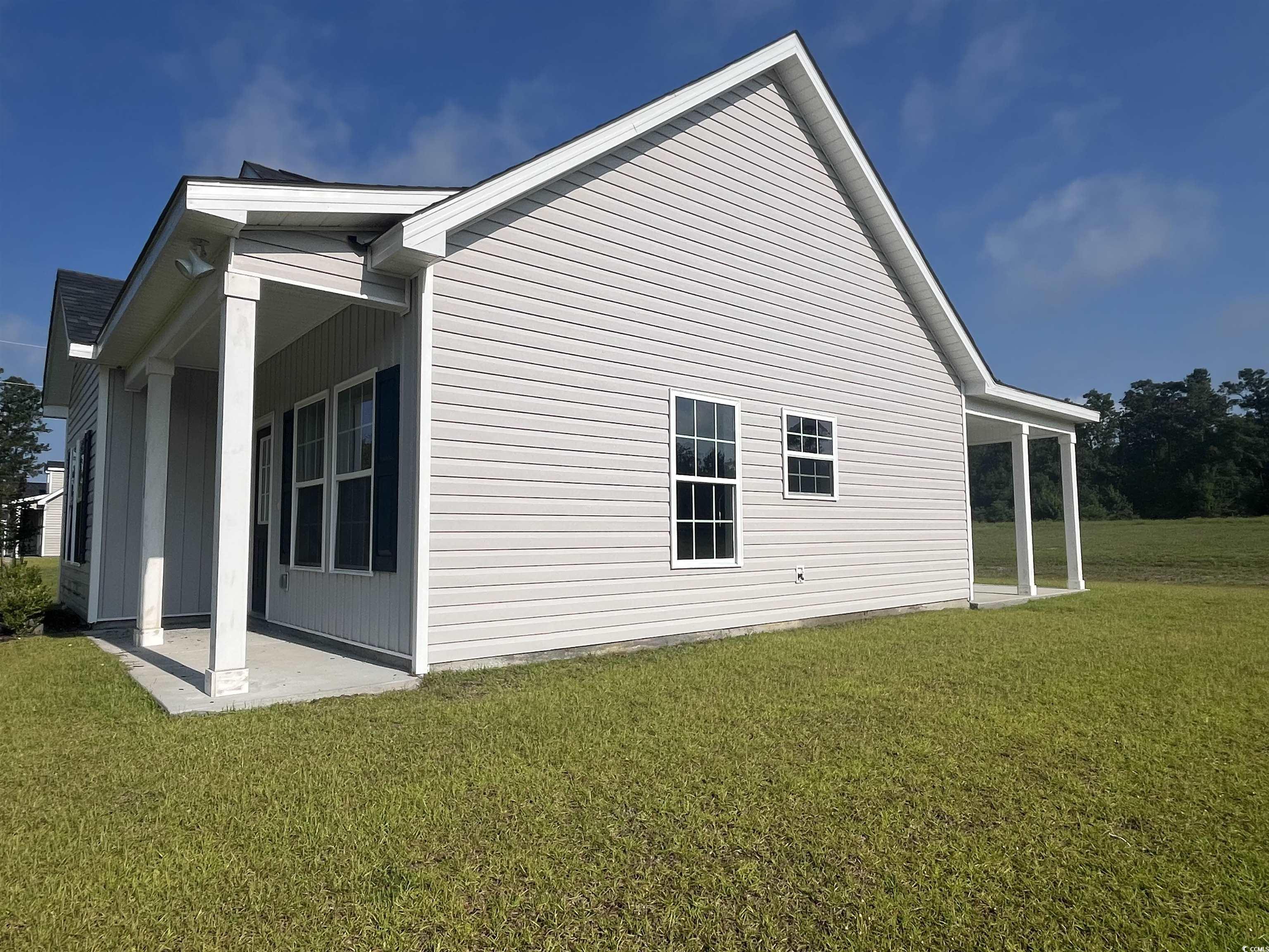 1174 St John Road Galivants Ferry, SC 29544 - Photo 19 of 22 View of side of property featuring a yard and a patio
