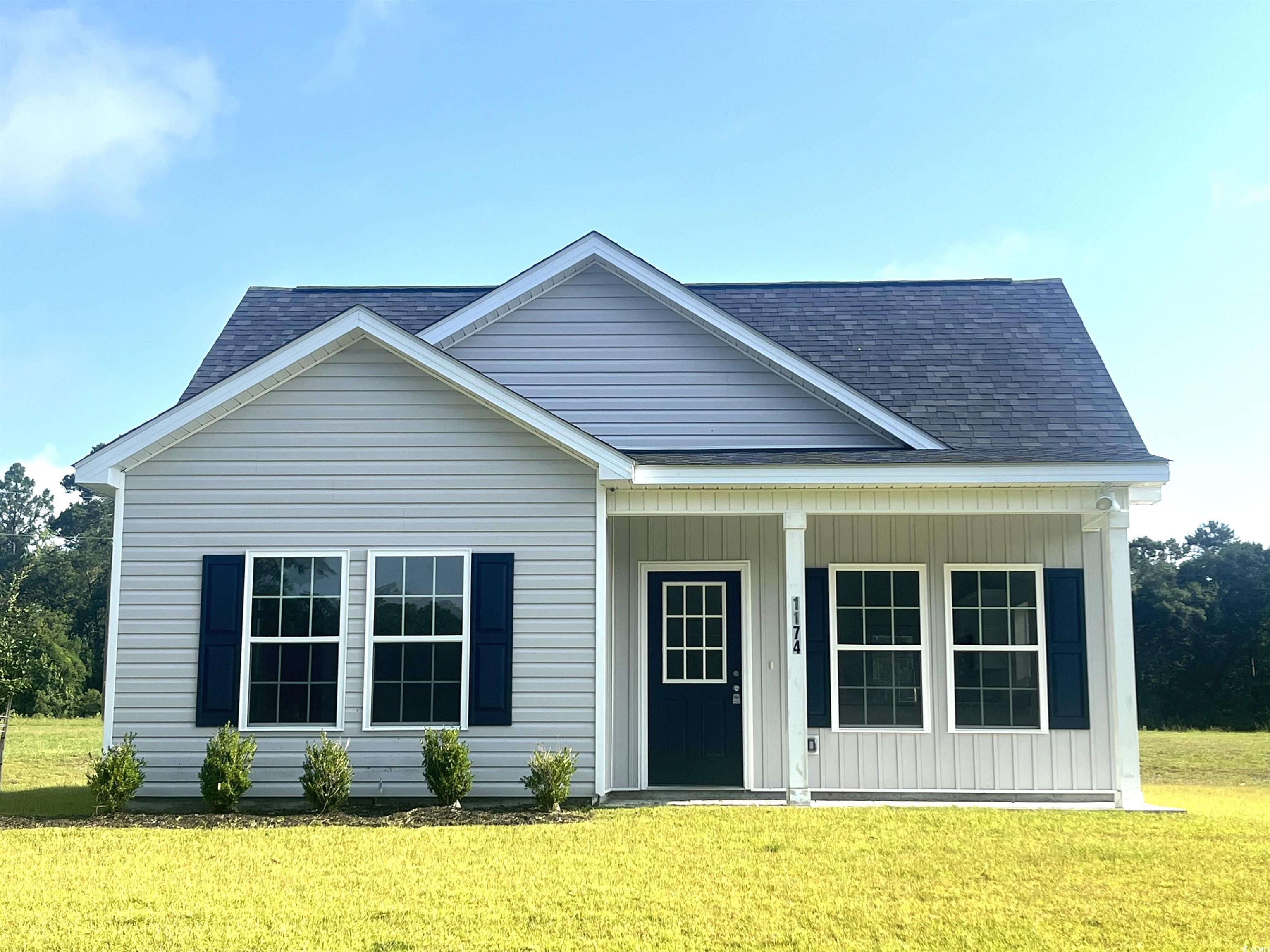 1174 St John Road Galivants Ferry, SC 29544 - Photo 2 of 22 View of front of property with a front lawn, roof with shingles, and covered porch