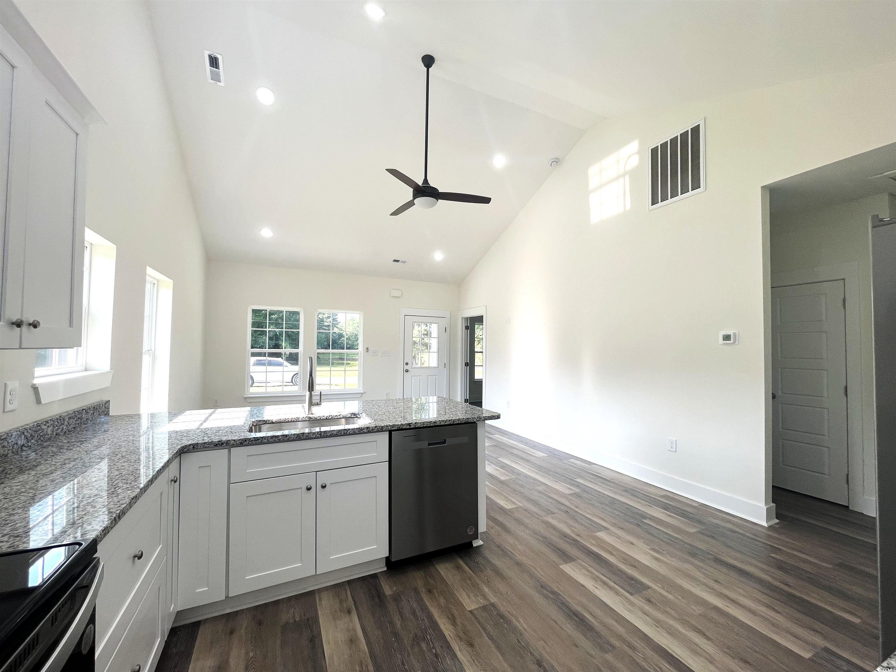 1174 St John Road Galivants Ferry, SC 29544 - Photo 8 of 22 Kitchen featuring stainless steel dishwasher, a ceiling fan, high vaulted ceiling, a peninsula, and dark wood-type flooring