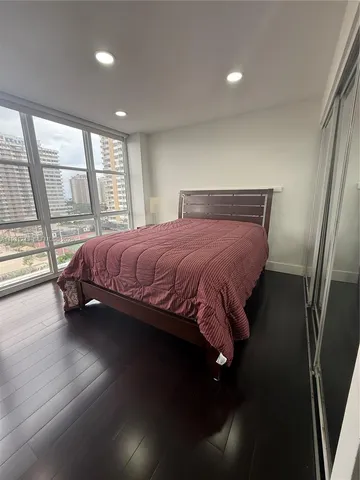 a bedroom with a bed lamps and window