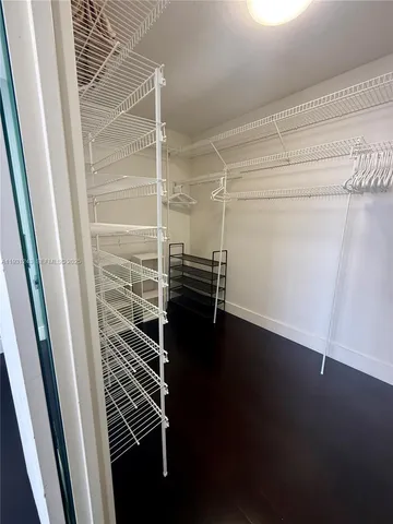 a view of walk in closet with empty racks