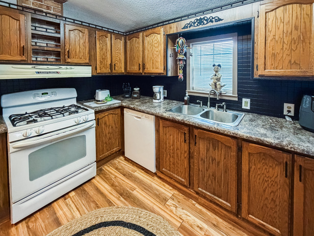 38569 North Sheridan Road, Unit 390 Beach Park, IL 60099 - Photo 8 of 28 a kitchen with granite countertop a sink stainless steel appliances and cabinets