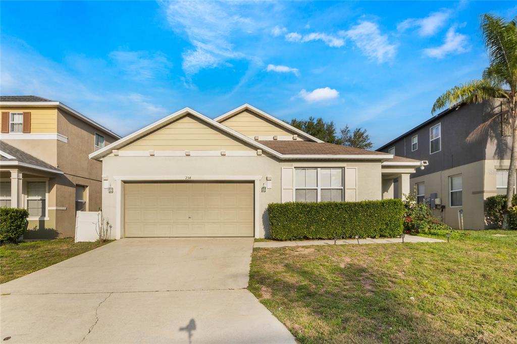 234 Kettering Road Davenport, FL 33897 - Photo 1 of 1 a front view of a house with a yard and garage