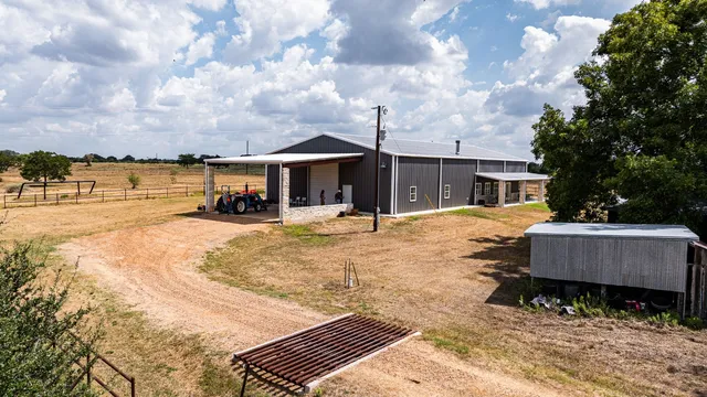 a view of a house with swimming pool and sitting area