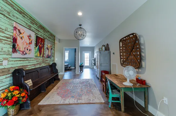 a view of a room with furniture and wooden floor