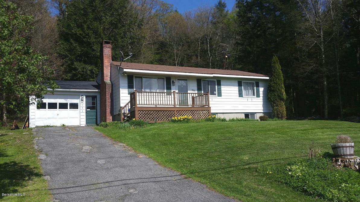 161 Main Road Tyringham, MA 01264 - Photo 1 of 15 a front view of a house with a garden and yard