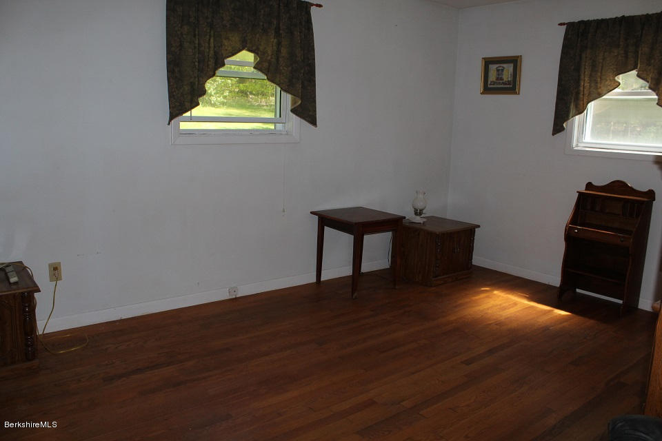 161 Main Road Tyringham, MA 01264 - Photo 7 of 15 a room with wooden floor and a window