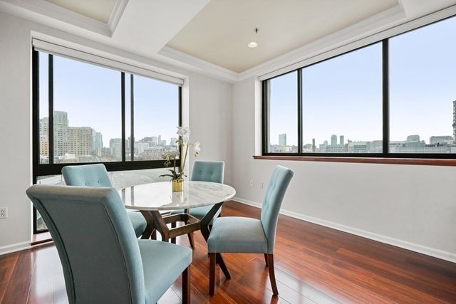 a view of a dining room with furniture window and wooden floor