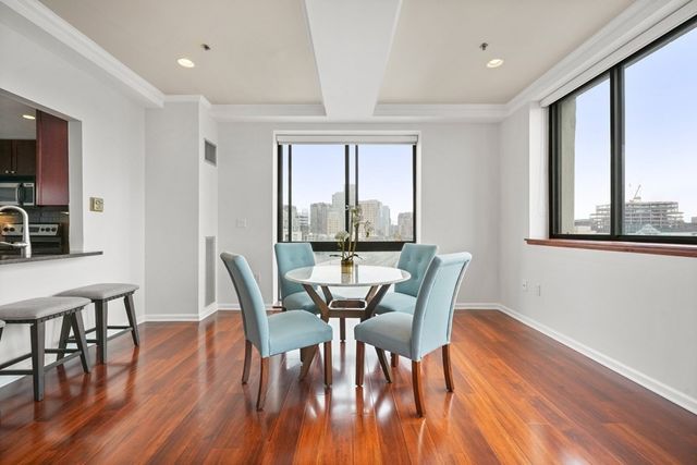a view of a dining room with furniture window and wooden floor