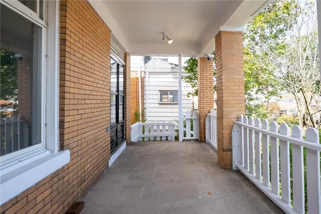 a view of a porch with wooden floor and stairs