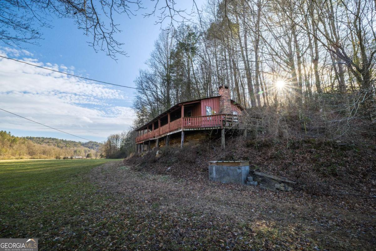 3771 Gates Chapel Road Ellijay, GA 30540 - Photo 10 of 12 a backyard of a house with table and chairs