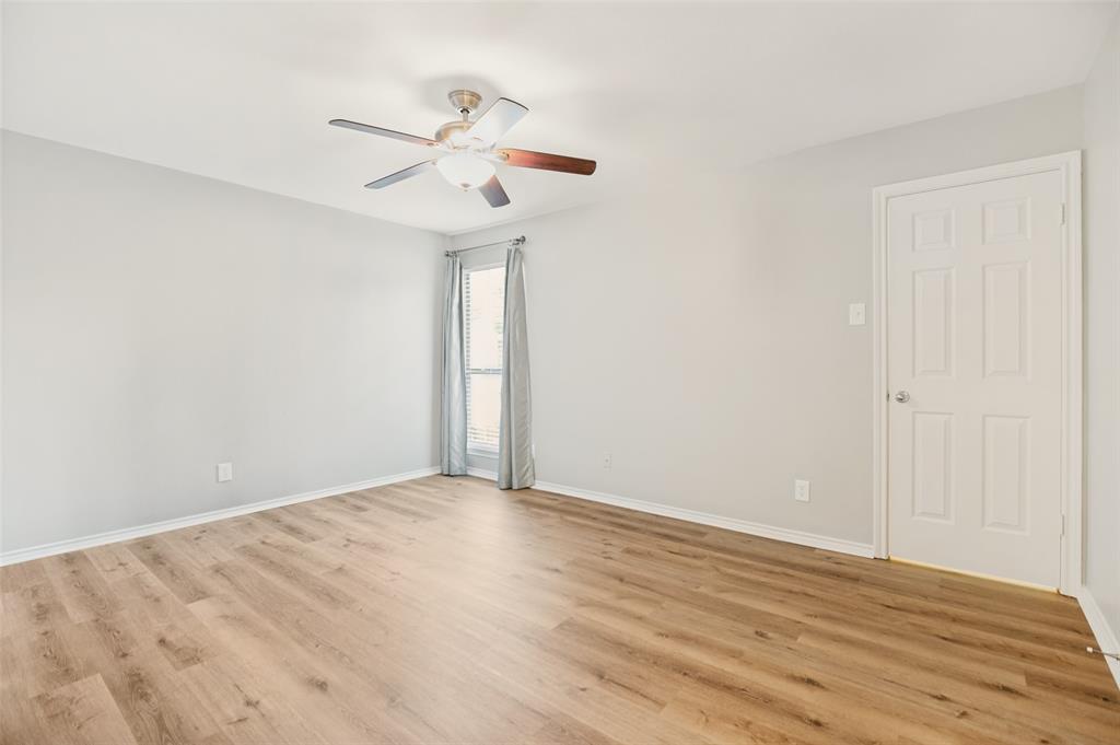 16301 Ledgemont Lane, Unit 263 Addison, TX 75001 - Photo 15 of 25 Spacious interior room featuring wood-finish flooring, light neutral wall tones, and white trim