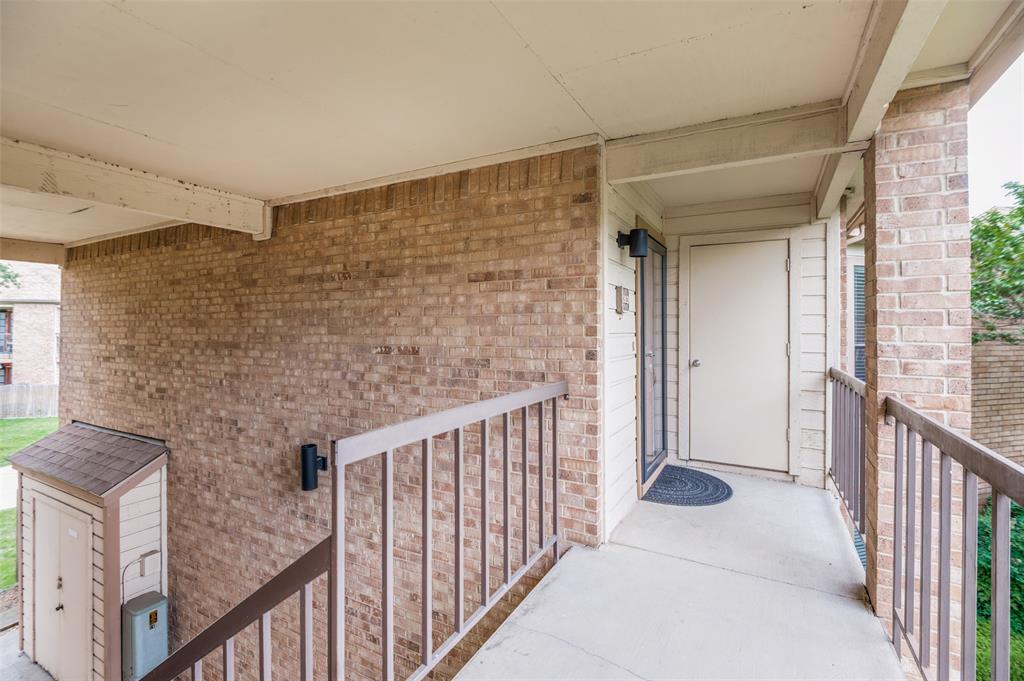 16301 Ledgemont Lane, Unit 263 Addison, TX 75001 - Photo 25 of 25 Entryway featuring a solid door, screen door, and exterior sconce lighting
