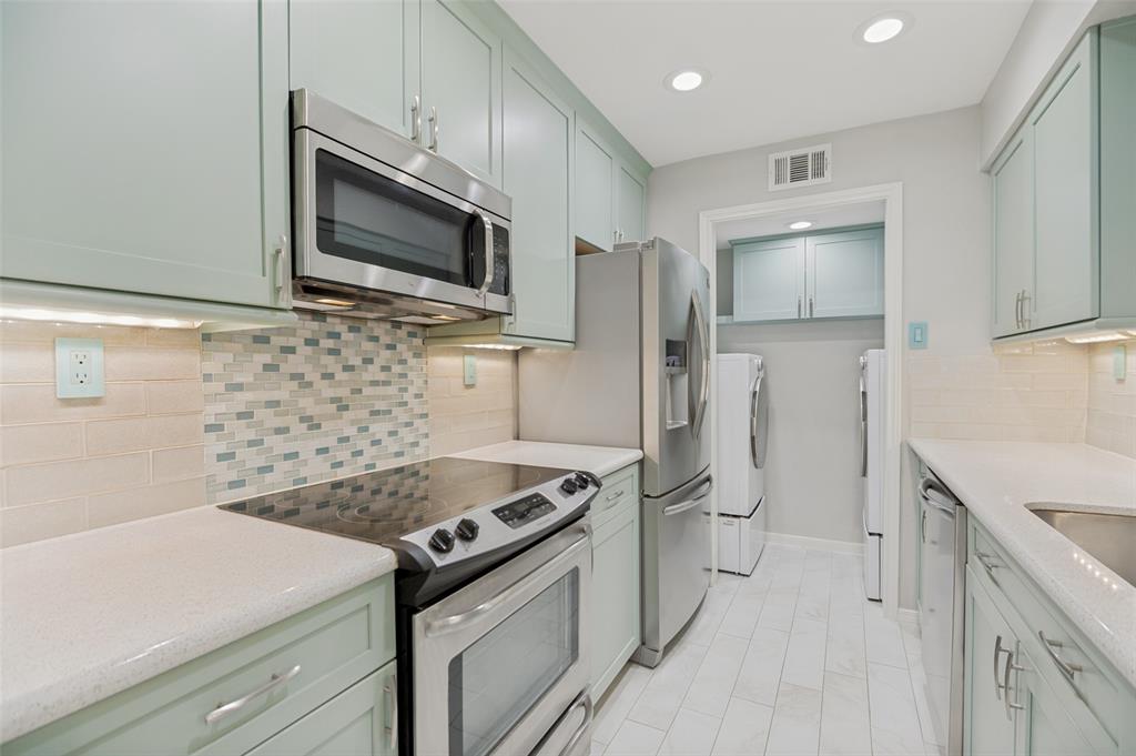 16301 Ledgemont Lane, Unit 263 Addison, TX 75001 - Photo 3 of 25 Modern kitchen featuring light green cabinetry and light-toned countertops