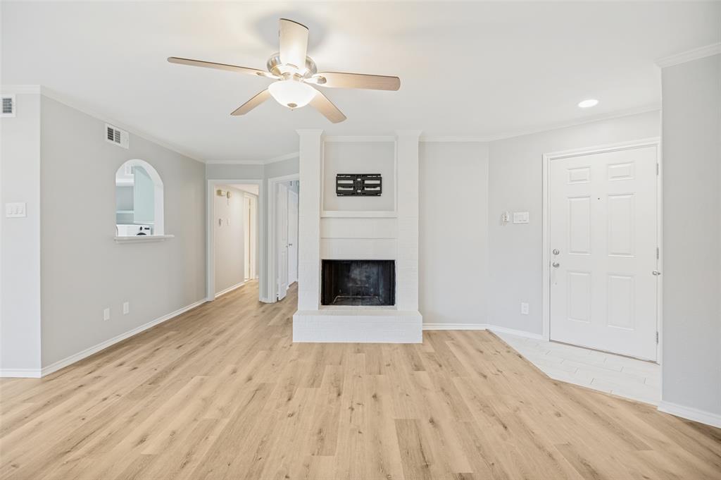 16301 Ledgemont Lane, Unit 263 Addison, TX 75001 - Photo 5 of 25 Brick entrance monument with a stone sign panel