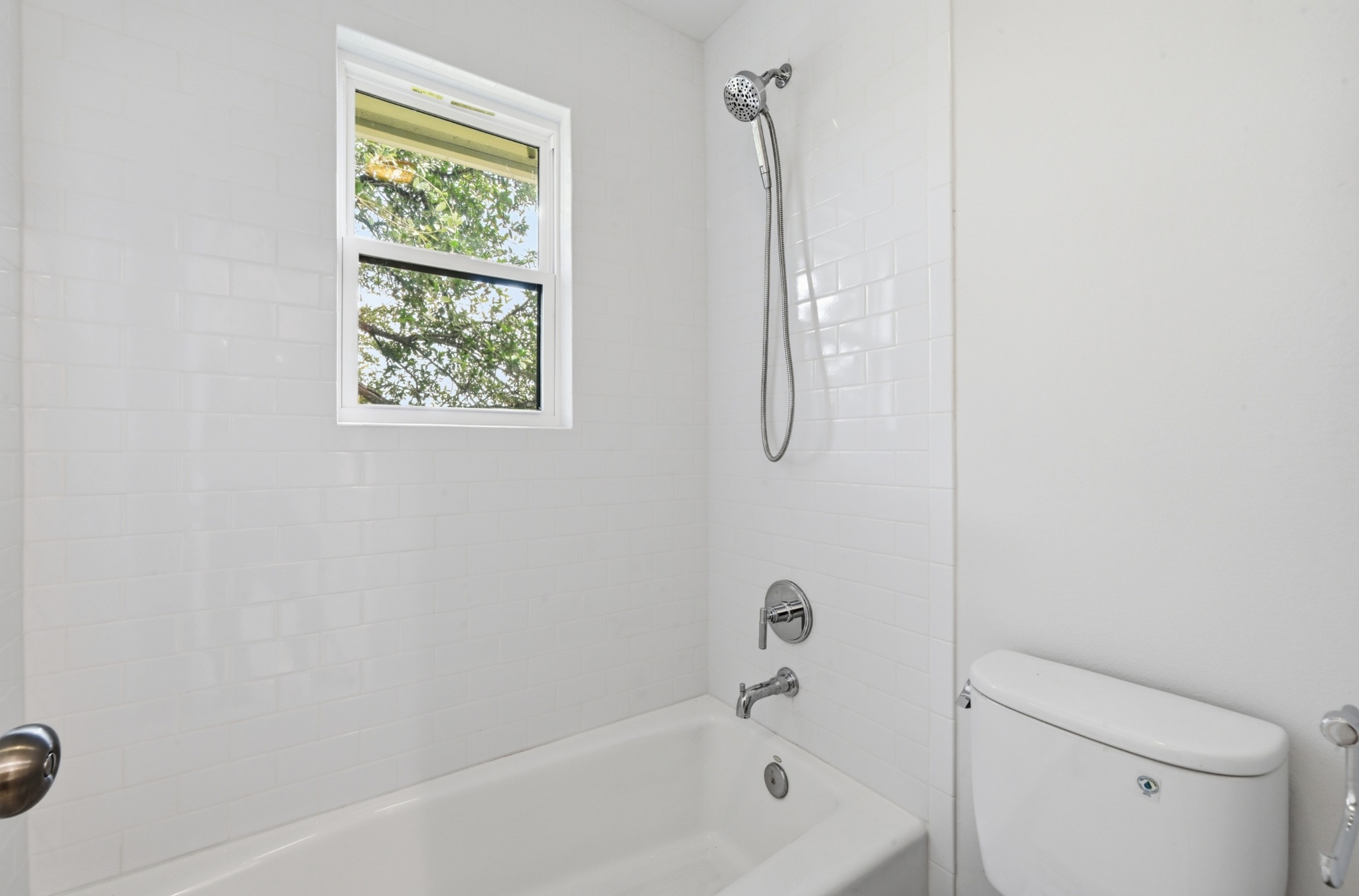 1107 Bowie Road Austin, TX 78733 - Photo 30 of 40 Bathtub and shower combo featuring a window for natural illumination.