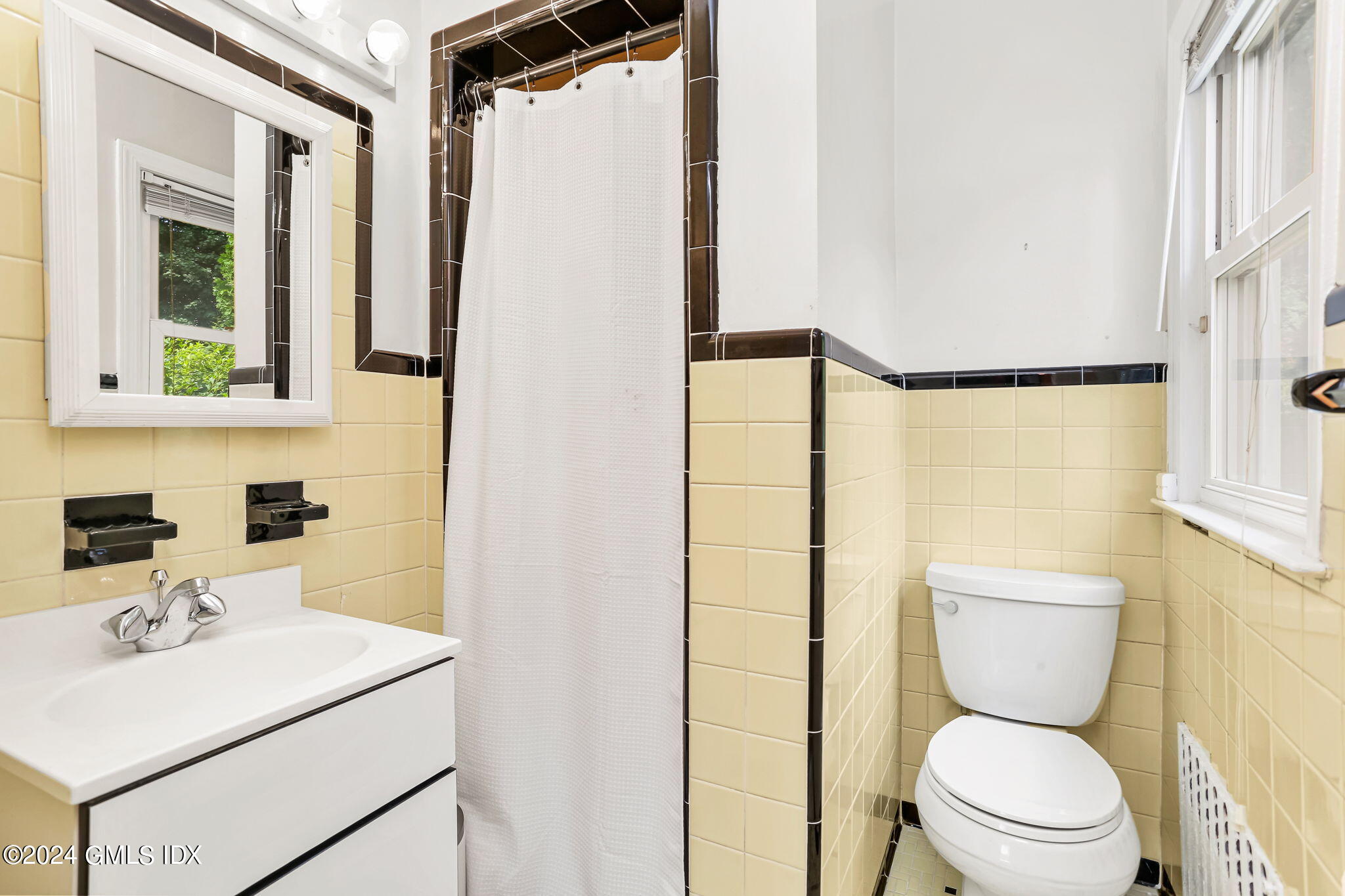 58 Arch Street Riverside, CT 06878 - Photo 16 of 21 a bathroom with a sink a toilet and a mirror