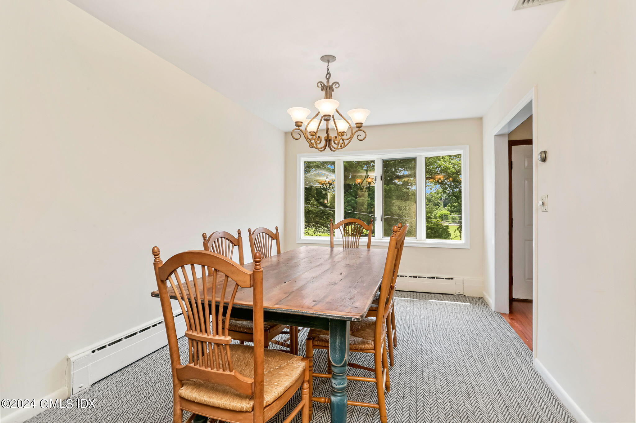 58 Arch Street Riverside, CT 06878 - Photo 10 of 21 a view of a dining room with furniture wooden floor and chandelier