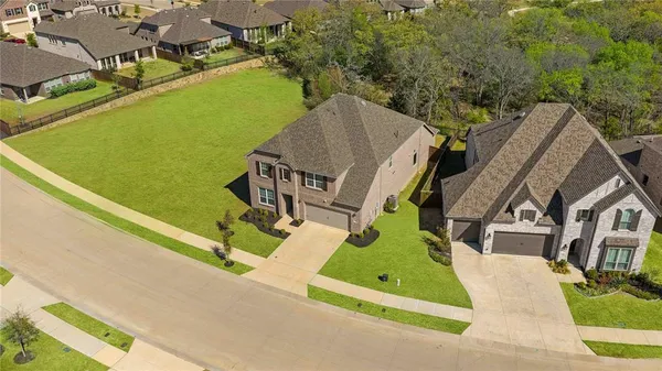 an aerial view of a house with a garden and swimming pool