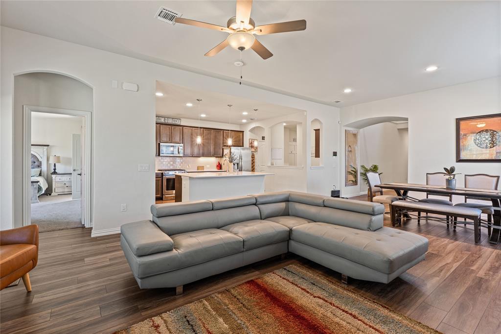 9517 Sunset Lane Oak Point, TX 75068 - Photo 12 of 40 9517 Sunset Lane, Oak Point, TX 75068 - living room - Living room featuring arched walkways, a ceiling fan, dark wood-style flooring, and recessed lighting