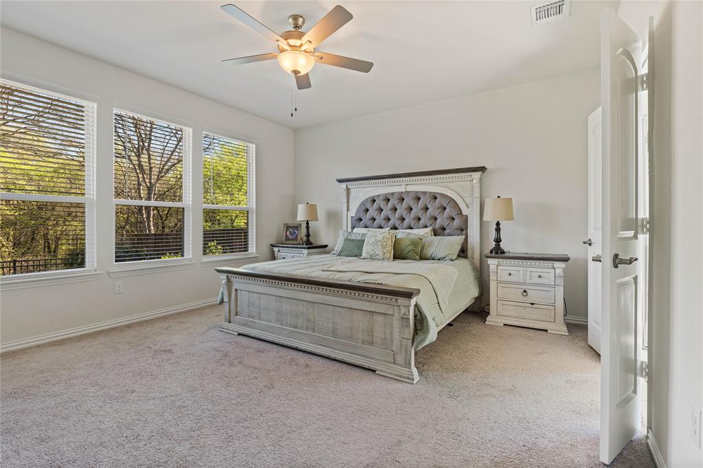 9517 Sunset Lane Oak Point, TX 75068 - Photo 18 of 40 9517 Sunset Lane, Oak Point, TX 75068 - primary bedroom - Bedroom with light carpet and ceiling fan